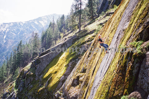 Rappelling A Mossy Cliff